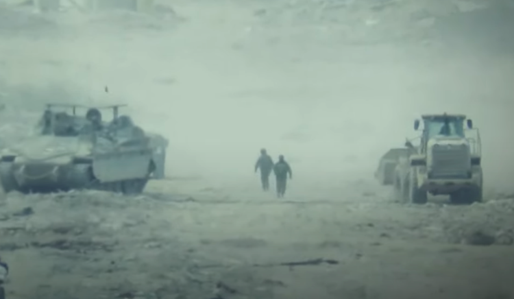 Israeli troops are seen after bulldozing the body of two killed Palestinian men.
