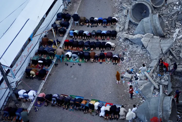 Somber Eid In Gaza 1 Palestinians hold Eid al-Fitr prayers by the ruins of al-Farouk mosque in Rafah, in the southern Gaza Strip on Wednesday, April 10, 2024.