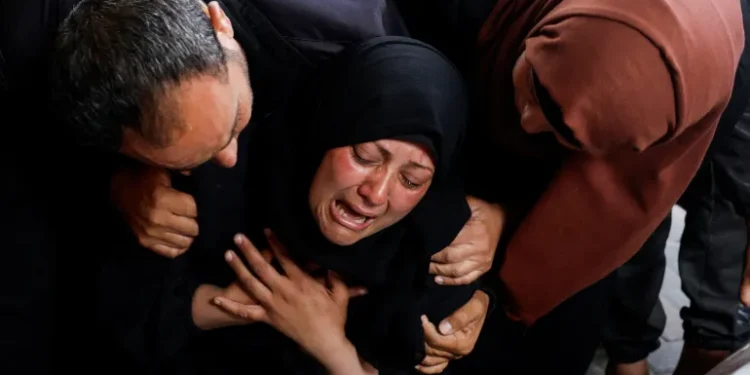 A woman reacts next to the bodies of relatives killed in Israeli attacks in Rafah.