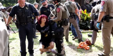 Law enforcement carry a pro-Palestinian protester at the University of Texas at Austin.