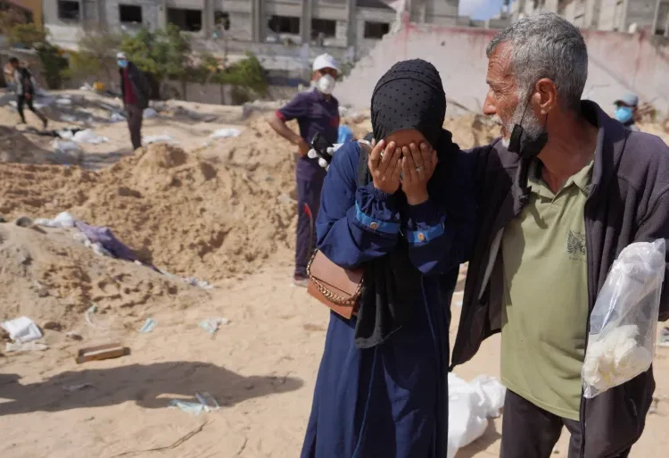 Palestinians react after the body of a relative is found buried at Nasser Hospital in Khan Younis.