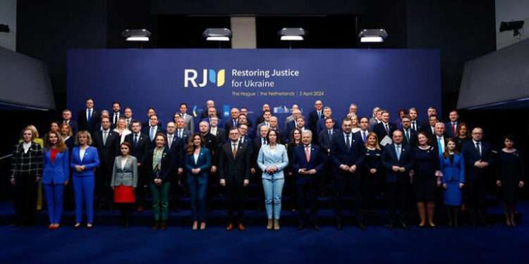 Attendees of the international peace conference 'Restoring Justice for Ukraine' pose for a family photo, in The Hague, Netherlands, April 2, 2024.