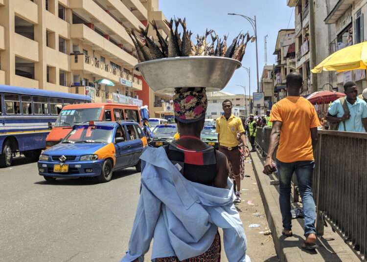 Ghana's Informal Workers Left Behind 1 A smoked fish seller walks around the market for people to buy her fish in Accra, Ghana