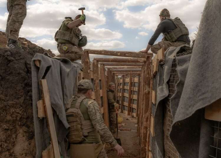 EU Reaches Deal To Use Profits From Russia’s Frozen Assets 1 Ukrainian servicemen prepare a trench system in the Donetsk region.