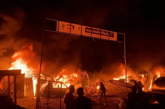 Fire rages following an Israeli strike on a tent camp for displaced Palestinian in Rafah.