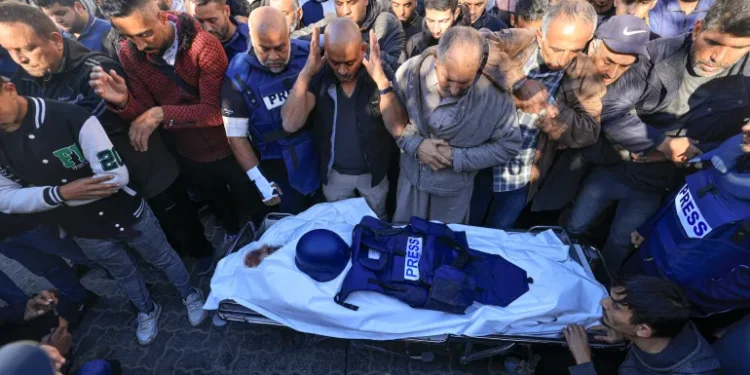 ActionAid Hails Palestinian Journalists 1 Colleagues and family members pray at the funeral of Al Jazeera cameraman Samer Abudaqa in Khan Younis, Gaza.