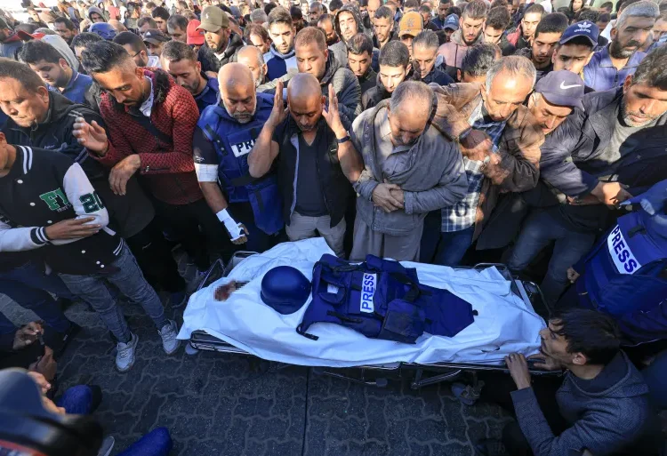 ActionAid Hails Palestinian Journalists 1 Colleagues and family members pray at the funeral of Al Jazeera cameraman Samer Abudaqa in Khan Younis, Gaza.