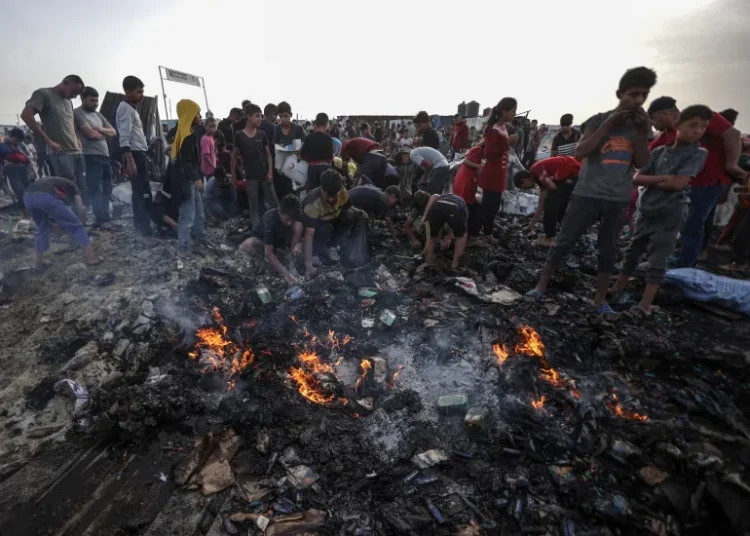 Gulf Between U.S Rhetoric and Gaza’s Reality Widens 1 Palestinians observe the destruction caused by an Israeli attack on tents of displaced Palestinians living near UNRWA warehouses in Rafah.