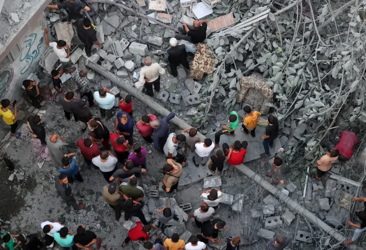 Palestinians search for survivors at the site of an Israeli strike on the Al-Daraj neighbourhood in Gaza.