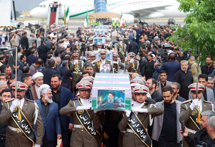 Soldiers carry the coffin of the late Iranian President, Ebrahim Raisi at Mehrabad Airport in Tehran.
