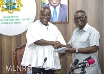 Hon. Samuel A. Jinapor receives report from Hon. Andy Kwame Appiah Kubi