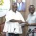 Hon. Samuel A. Jinapor receives report from Hon. Andy Kwame Appiah Kubi