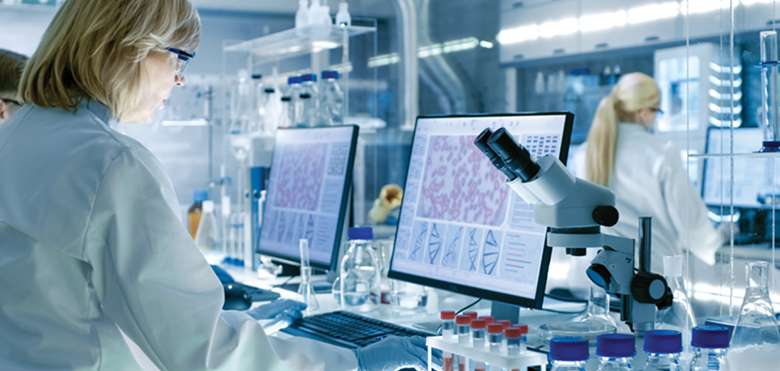 Pharmaceutical Industry to Embrace Digital Innovation for Enhanced Healthcare 2 Woman Scientist Screens Microscope DNA Medical Research