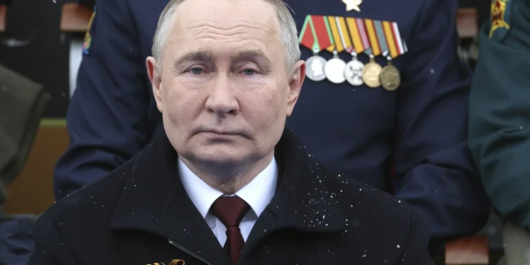 Russian President, Vladimir Putin sits during the Victory Day military parade on May 9, 2024.
