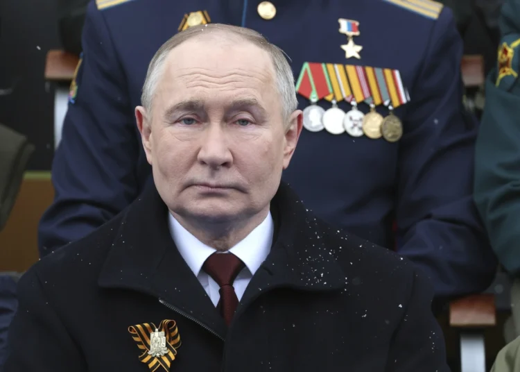 Russian President, Vladimir Putin sits during the Victory Day military parade on May 9, 2024.