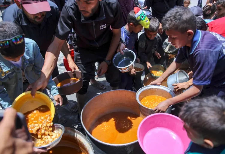 Curbing Gaza’s Hunger Crisis Exceeds Mere Food Distribution 1 Children line up to receive food in Jabalia camp, June 17, 2024.