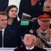 Britain's King Charles, right, and French President Emmanuel Macron attend a ceremony in Normandy.