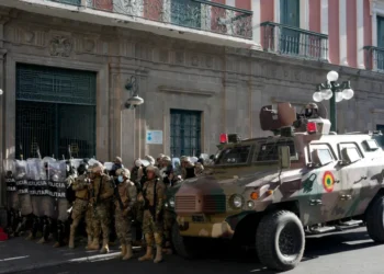 An armoured vehicle and military police form outside the government palace at Plaza Murillo in La Paz, Bolivia, on Wednesday, June 26, 2024.