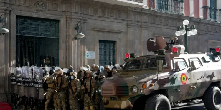 An armoured vehicle and military police form outside the government palace at Plaza Murillo in La Paz, Bolivia, on Wednesday, June 26, 2024.