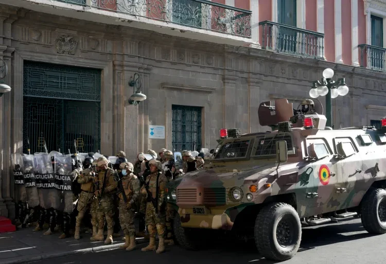 An armoured vehicle and military police form outside the government palace at Plaza Murillo in La Paz, Bolivia, on Wednesday, June 26, 2024.