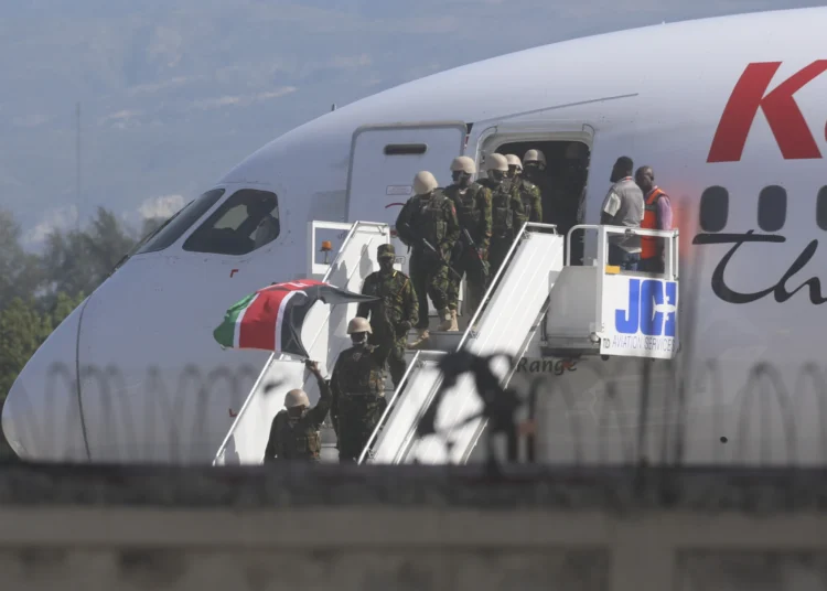 Police from Kenya deplane at the Toussaint Louverture International Airport in Port-au-Prince, Haiti.