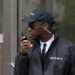 Young African Male Security Guard Talking On Walkie-Talkie