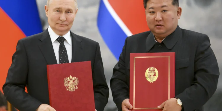 Russian President, Vladimir Putin and North Korean leader, Kim Jong-un pose for the cameras in Pyongyang after signing the deal.