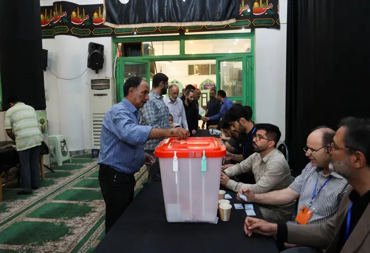 Runoff Election Underway In Iran 1 A man votes in the run-off presidential election between Masoud Pezeshkian and Saeed Jalili in Tehran.