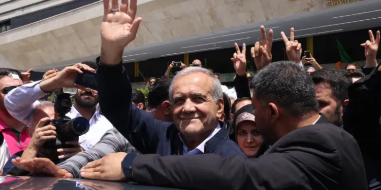 Pezeshkian Wins Iran’s Presidential Vote 1 Masoud Pezeshkian greets supporters outside a polling station in Tehran.