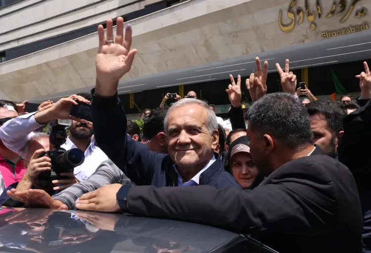 Pezeshkian Asserts Need For Iran To Move Capital From Tehran 1 Masoud Pezeshkian greets supporters outside a polling station in Tehran.