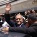 Masoud Pezeshkian greets supporters outside a polling station in Tehran.