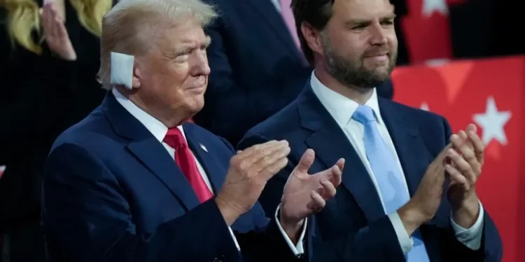 Donald Trump stands next to his vice-presidential pick, Senator JD Vance.