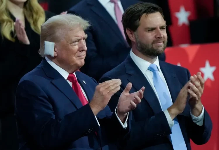 Donald Trump stands next to his vice-presidential pick, Senator JD Vance.