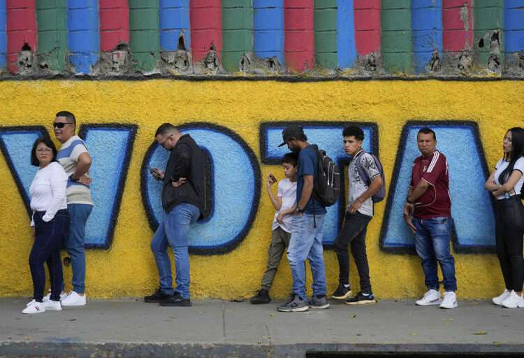 Venezuela Goes To The Polls 1 Voters line up outside a polling station during presidential elections in Caracas, Venezuela, Sunday, July 28, 2024.