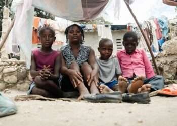 A mother sits with her children in an IDP site in Léogâne, on the outskirts of the Haitian capital, Port-au-Prince.