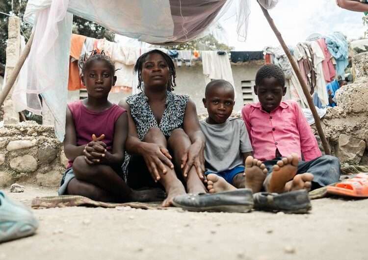 A mother sits with her children in an IDP site in Léogâne, on the outskirts of the Haitian capital, Port-au-Prince.