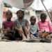 A mother sits with her children in an IDP site in Léogâne, on the outskirts of the Haitian capital, Port-au-Prince.