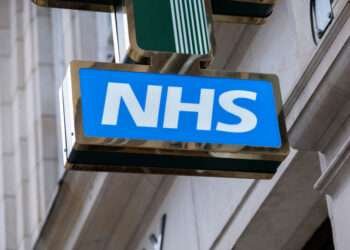 Sign for the NHS National Health Service outside a pharmacy