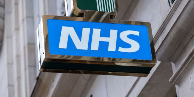 UK's 'Pre-NHS' Plan to Save Billions 1 Sign for the NHS National Health Service outside a pharmacy