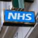 UK's 'Pre-NHS' Plan to Save Billions 11 Sign for the NHS National Health Service outside a pharmacy