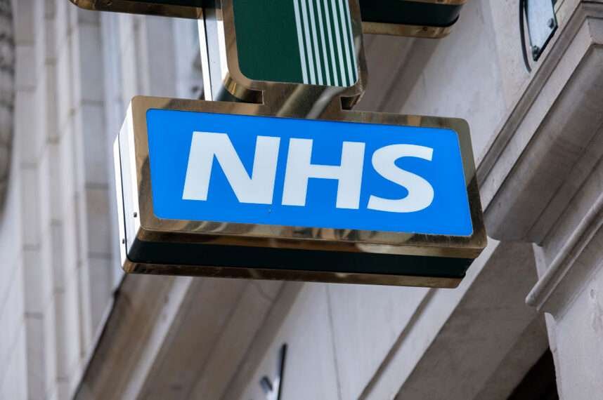 Sign for the NHS National Health Service outside a pharmacy