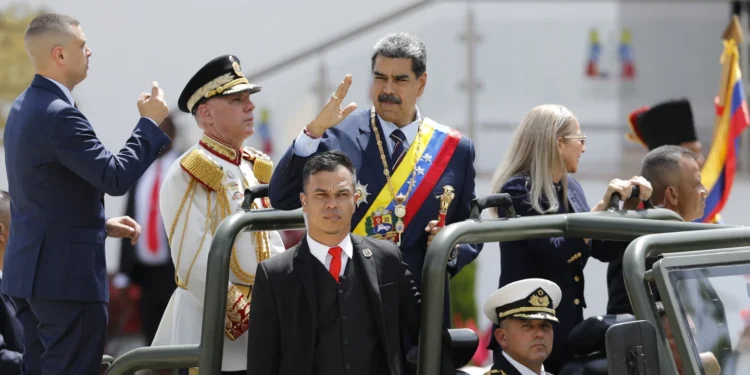 Maduro Bolsters Military Support Ahead of Contentious Election 1 President Nicolas Maduro waving while ride at the back of a military vehicle