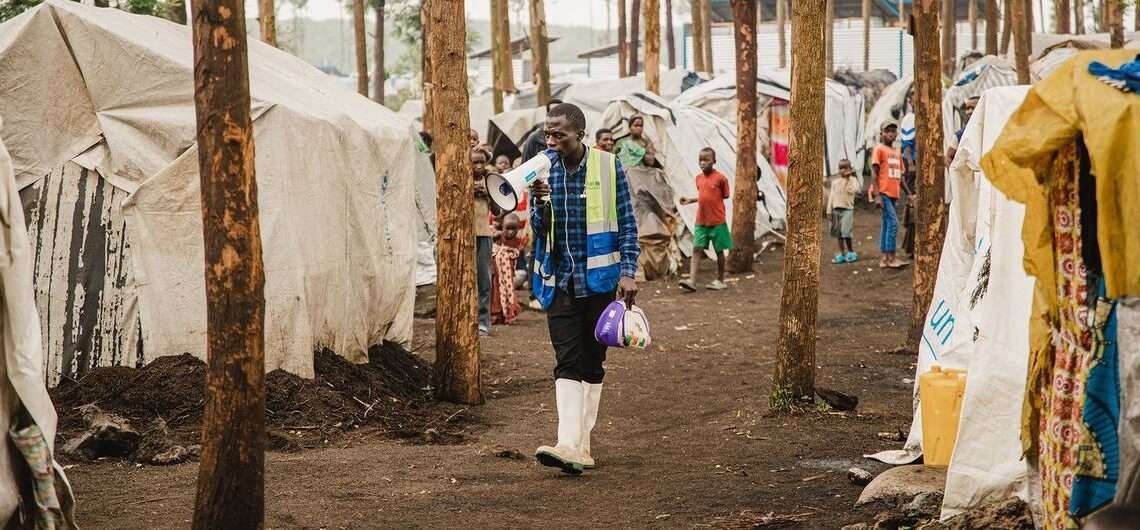 A community health worker walks through an IDP camp in North Kivu in eastern Democratic Republic of the Congo.