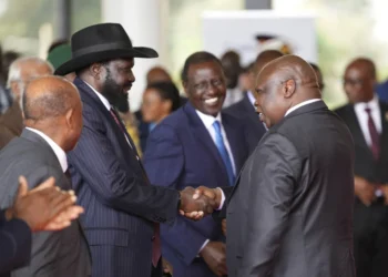 South Sudanese President Salva Kiir Mayardit, left, shakes hands with Pagan Amum Okiech, leader of the Real-SPLM group