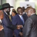 South Sudanese President Salva Kiir Mayardit, left, shakes hands with Pagan Amum Okiech, leader of the Real-SPLM group