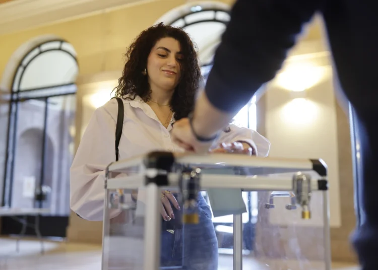 A woman casts her ballot in the second round of the legislative elections, Sunday, July 7, 2024 in Strasbourg, eastern France.