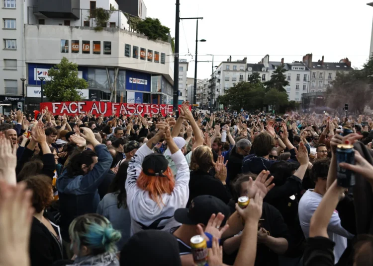 NFP Win in French Election Hailed 1 People react to second round vote results in France.