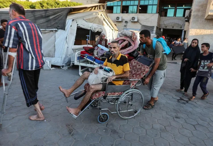 Palestinian patients fearing an Israeli ground operation are helped to flee Al-Aqsa Martyrs Hospital in Deir el-Balah in the central Gaza Strip.