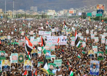 Yemenis wave flags and lift placards of Hezbollah senior commander Fuad Shukr, who was killed in an Israeli strike, and slain Hamas chief Ismail Haniyeh, during a rally in the Houthi-controlled capital Sanaa.
