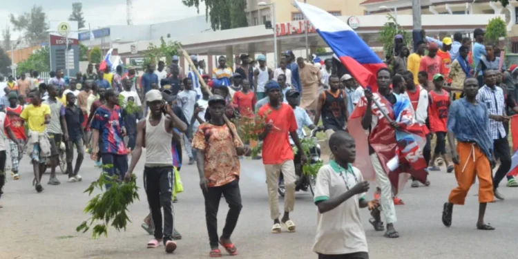 Polish Students Released After Detention in Nigeria 1 People wave Russian flags during a protest in Kaduna, Nigeria, Monday, Aug 5, 2024.